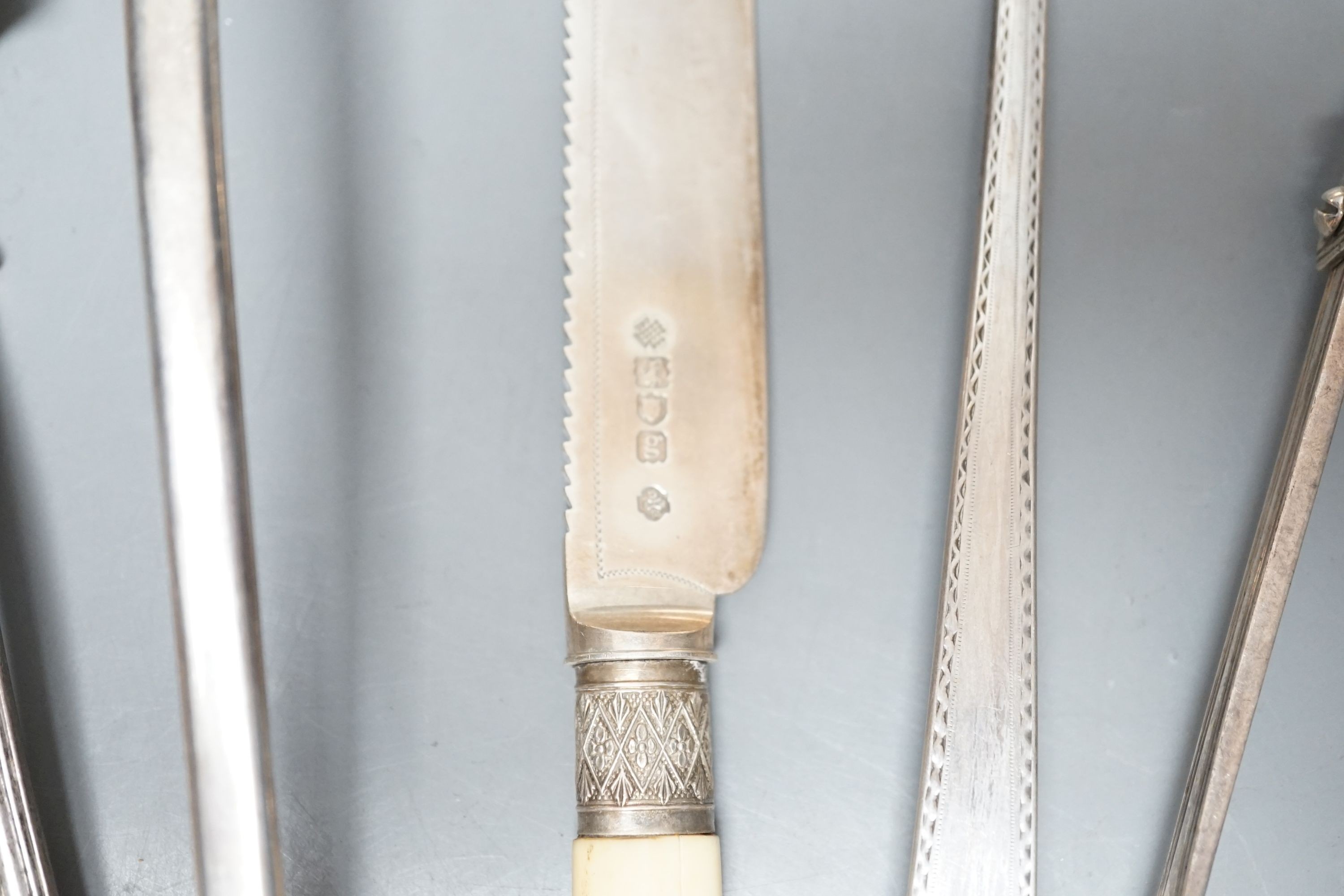 A George III Irish silver Celtic tip soup ladle, Dublin, 1789, A Georgian Irish silver marrow scoop, by William Walsh, two later Victorian silver soup ladles, a pair of Victorian silver asparagus tongs, two silver bastin